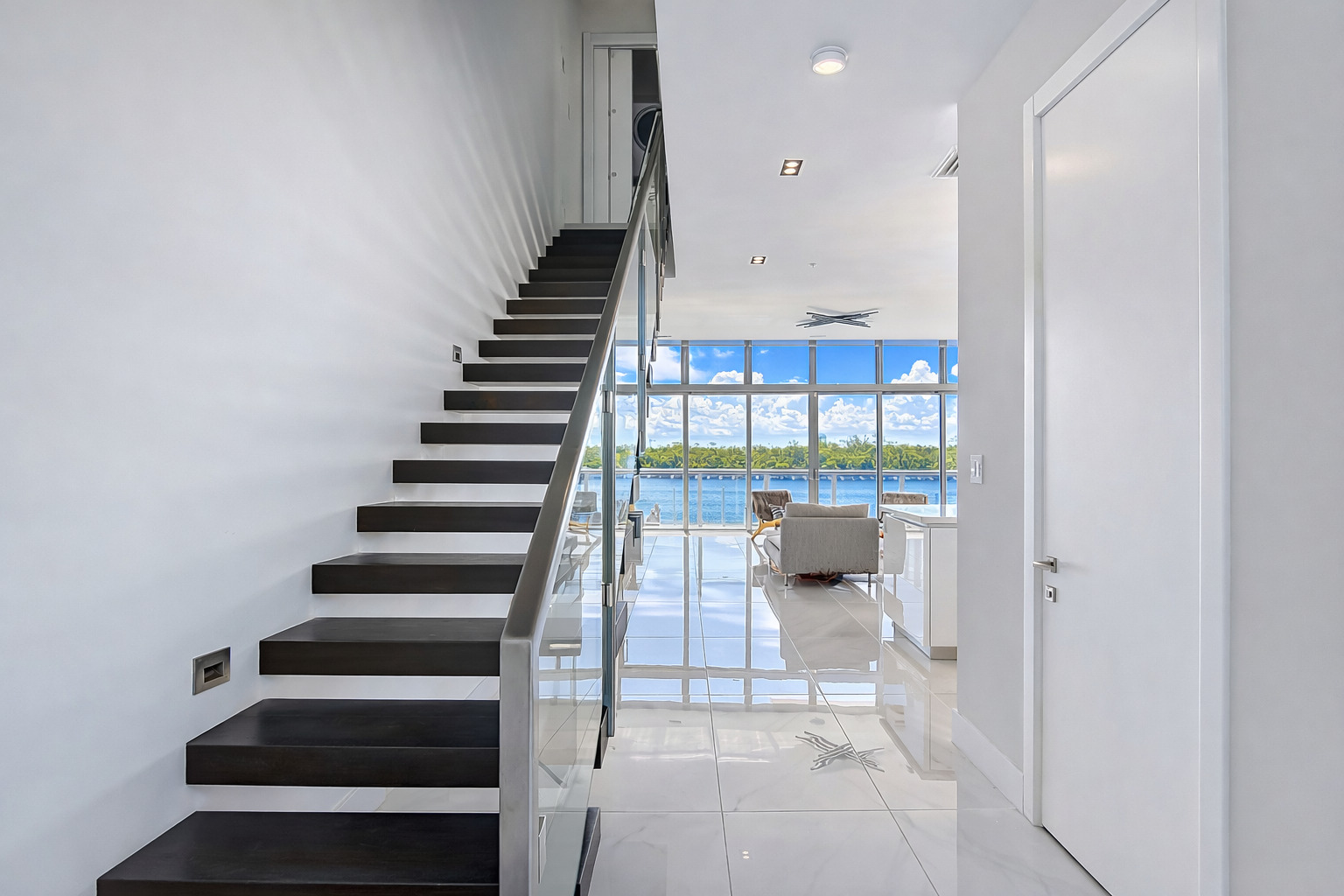 Floating wood staircase with glass railing