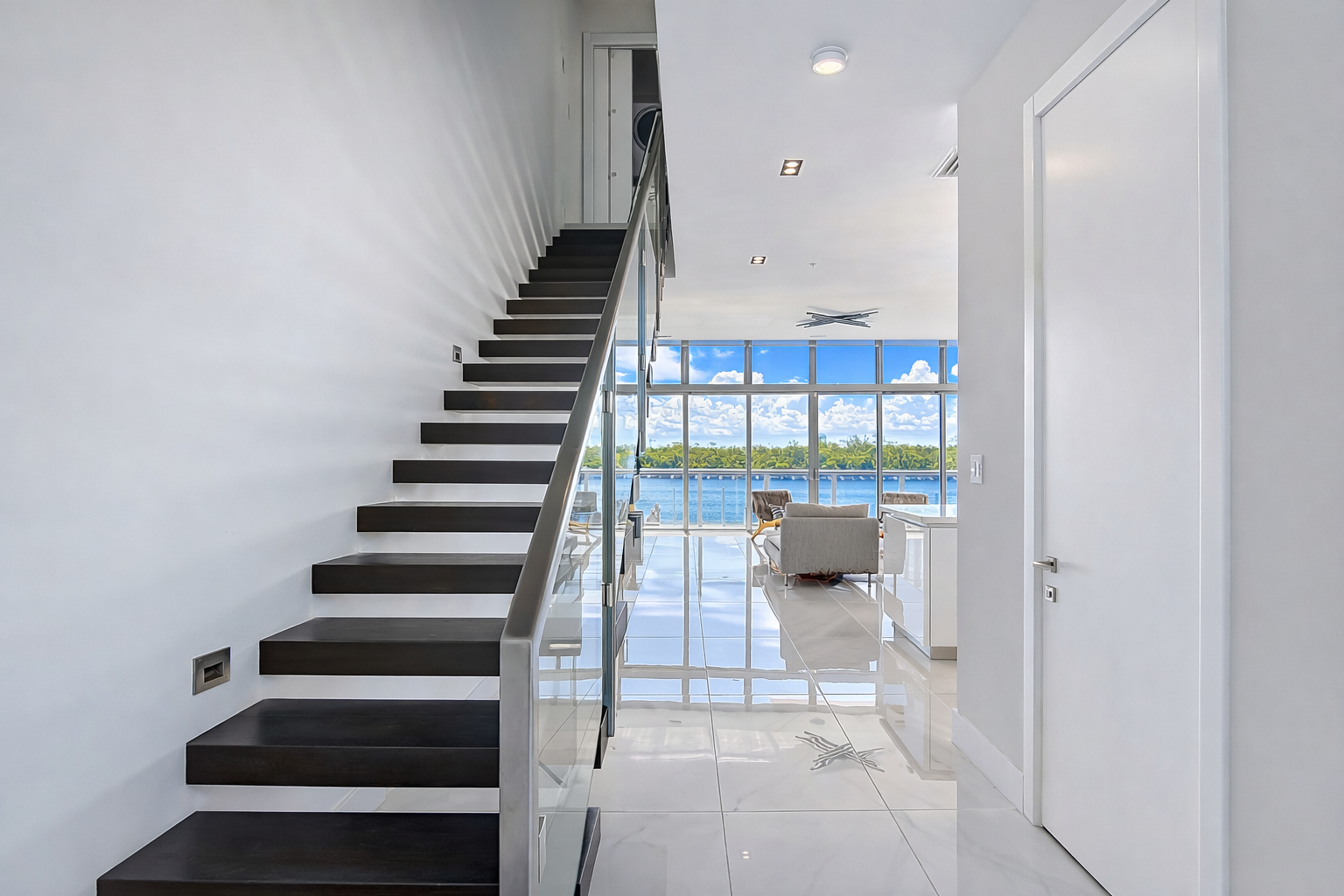 Floating wood staircase with glass railing